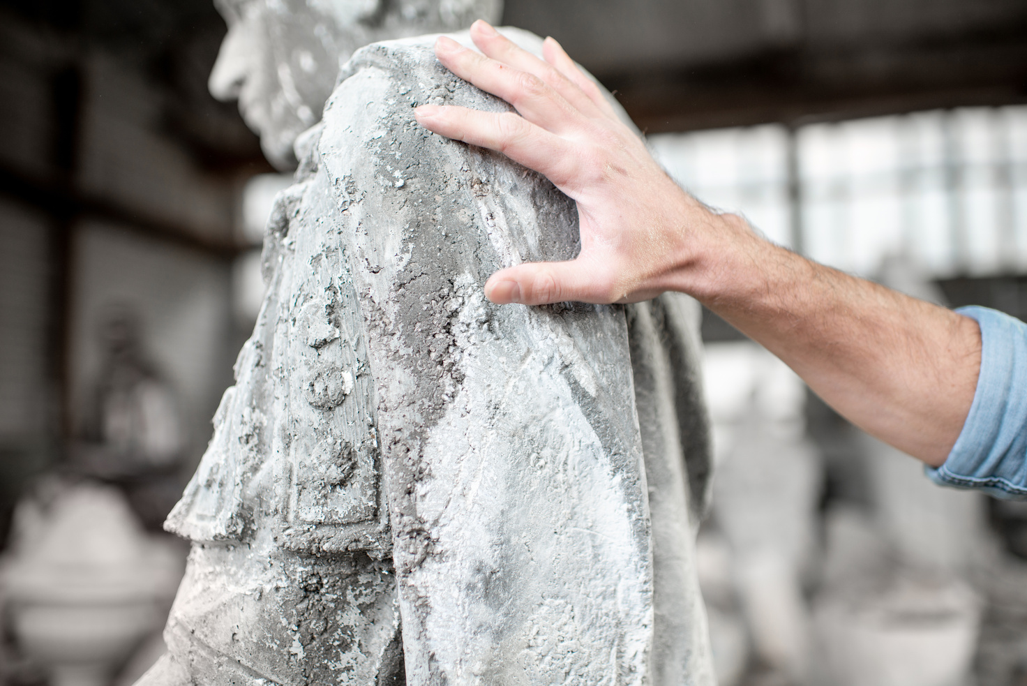 Touching old sculpture in the studio