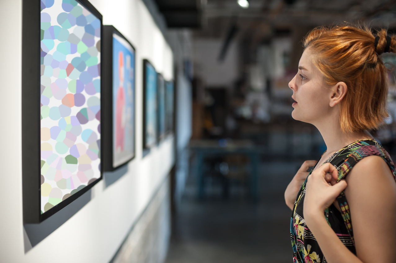 Young woman in modern art exhibition gallery hall